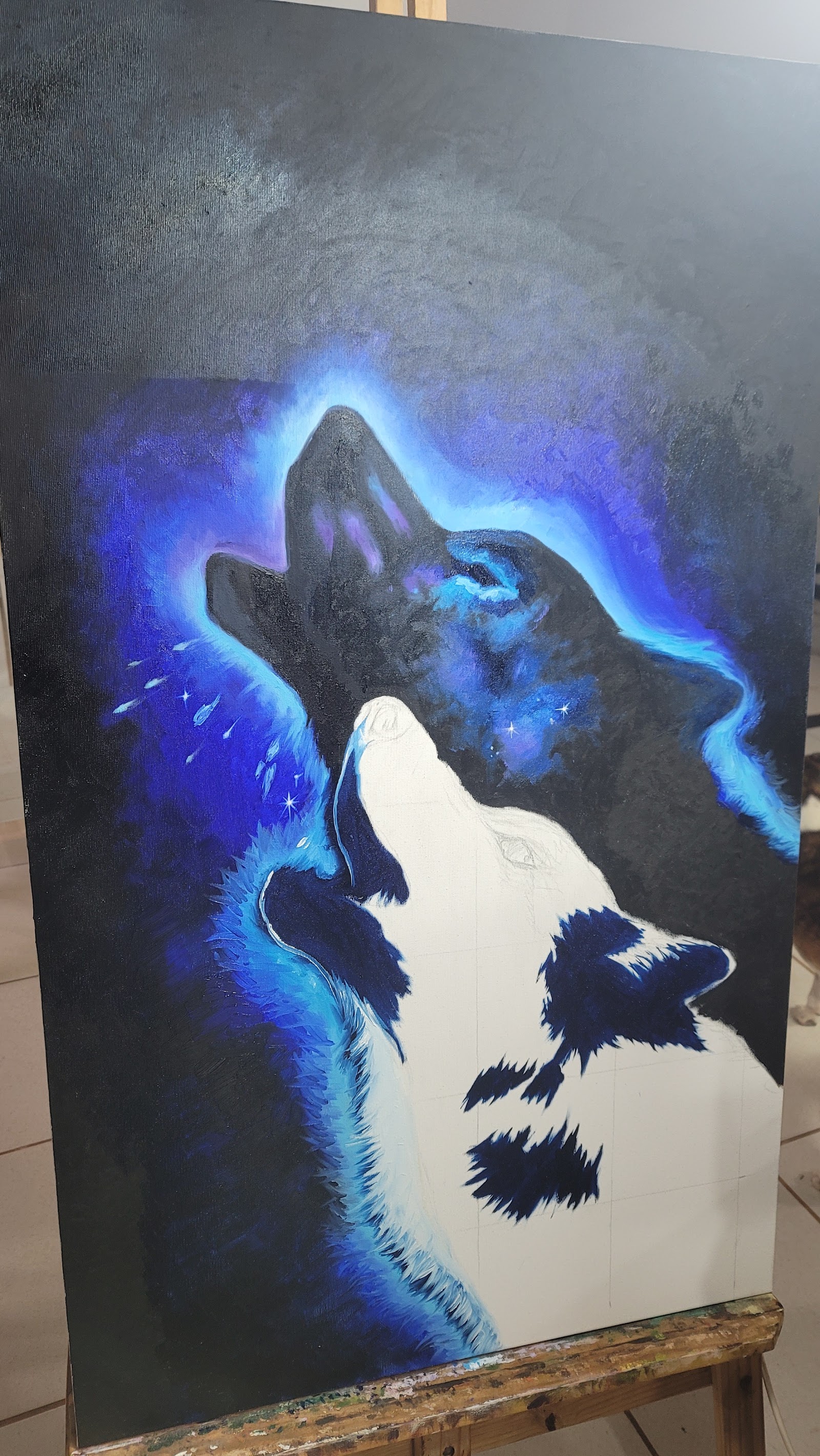 Três lobos em construção na tela, em tons de azul e branco