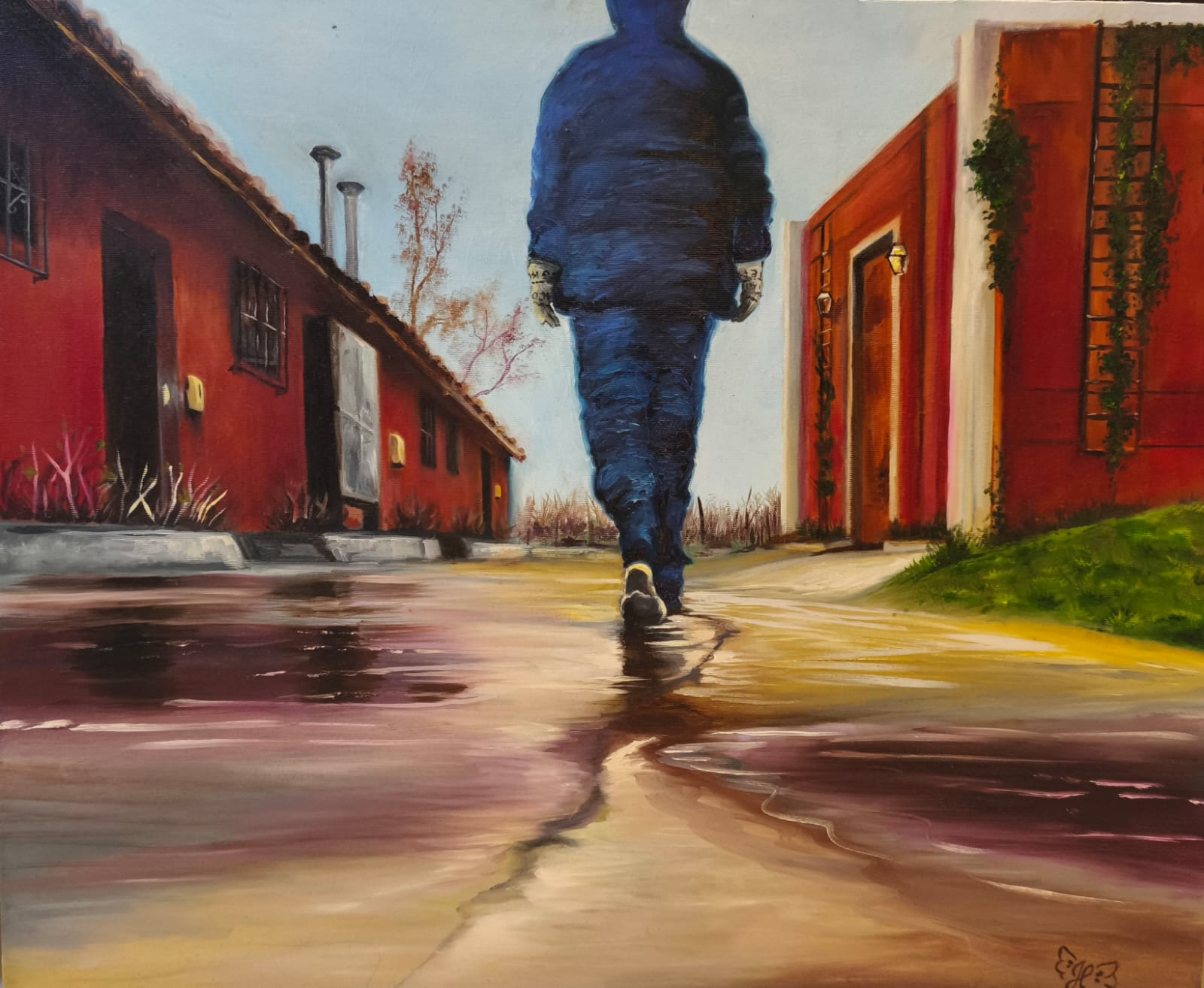 Menino de azul caminhando por uma rua molhada entre casas vermelhas